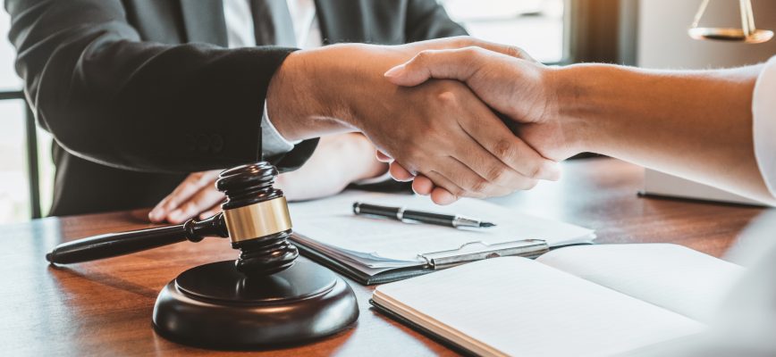 Businessman shaking hands to seal a deal Judges male lawyers Consultation legal services Consulting in regard to the various contracts to plan the case in court.